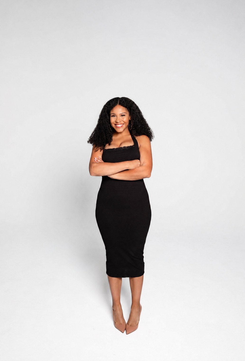 Ms. Hood, founder of Beauty University PDX, smiling with arms crossed